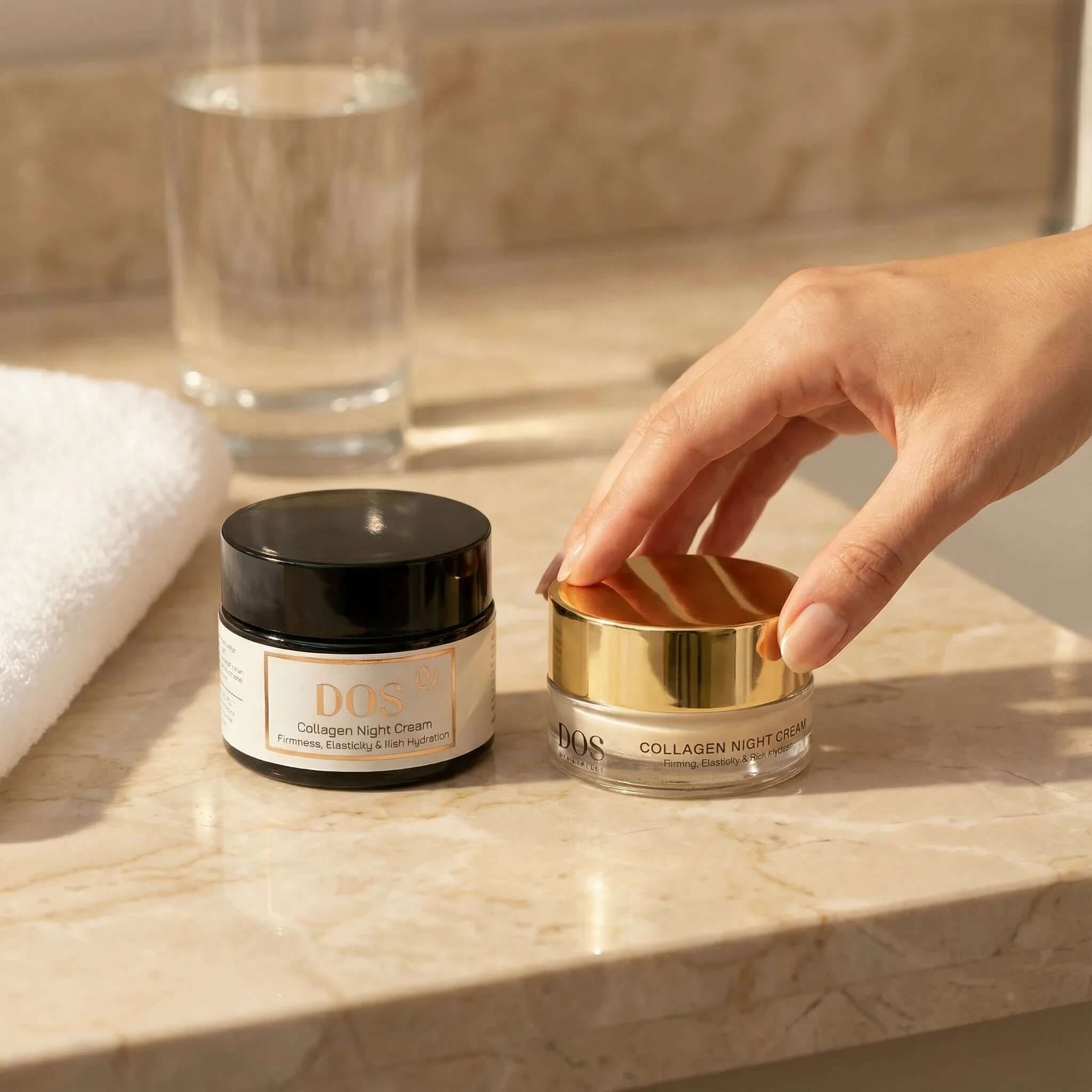 Two jars of collagen night cream on a marble countertop, showcasing luxurious skin care for overnight renewal. DOS Cosmetics