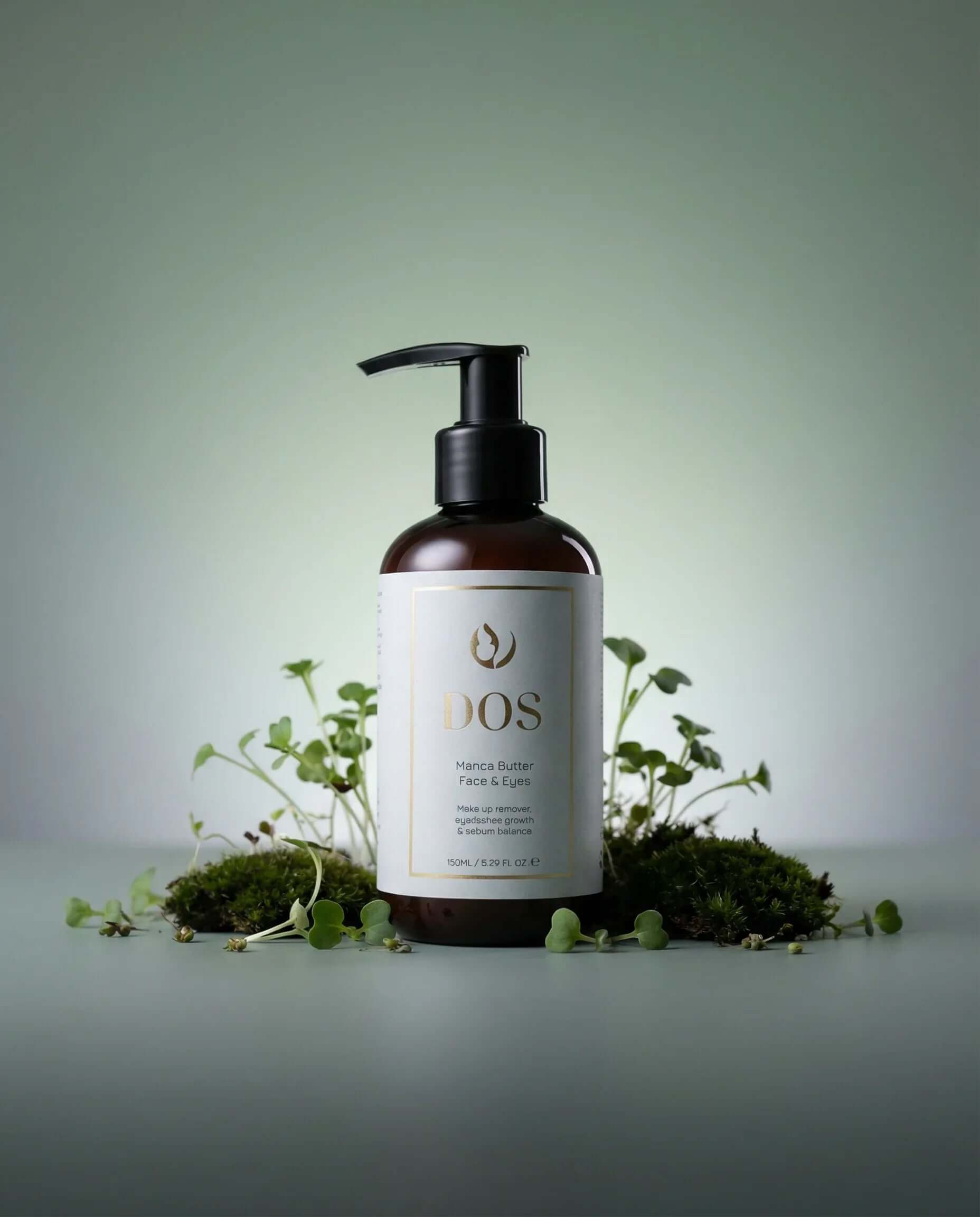 Makeup remover Manca Butter Face & Eyes bottle with pump, surrounded by natural elements, highlighting gentle cleansing for sensitive skin. DOS Cosmetics