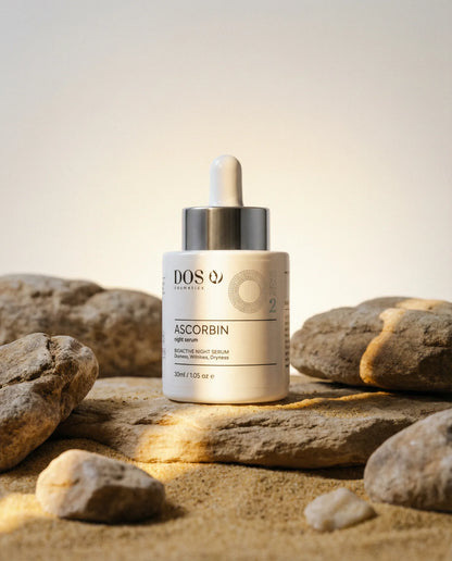 DOS Cosmetics Ascorbin serum bottle on rocks with a warm glow for dark spots and radiance