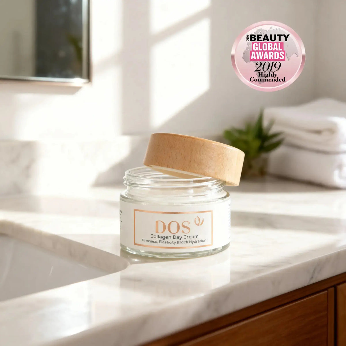 Collagen day cream jar with wooden lid on marble countertop, featuring beauty award sticker, ideal for hydration and firming. DOS cosmetics