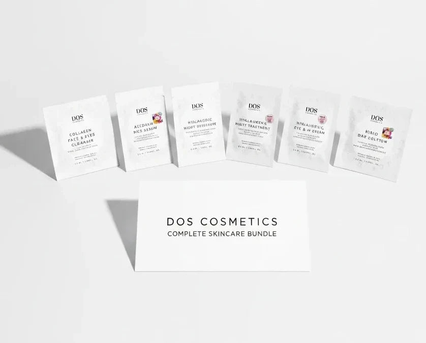 Six small white skincare sachets arranged in a row on a light gray background, with a white card in front reading &